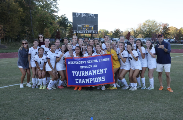 The girls team poses for a picture with their ISL banner